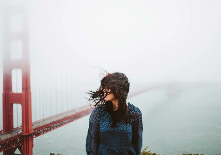 San Francisco Acupuncture Group- an adult with long hair outside by Golden Gate Bridge