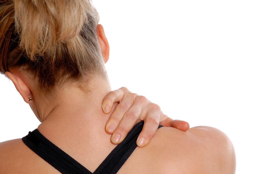 woman in training gear holding her neck in pain