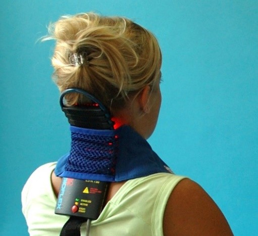 PBM Therapy & Laser Therapy, image of a PBM Therapy and Laser Therapy device strapped to the back of a woman patient's neck.