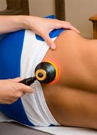 PBM Therapy & Laser Therapy, image of a physician using a PMB Therapy and Laser Therapy device on a patient's lower back.